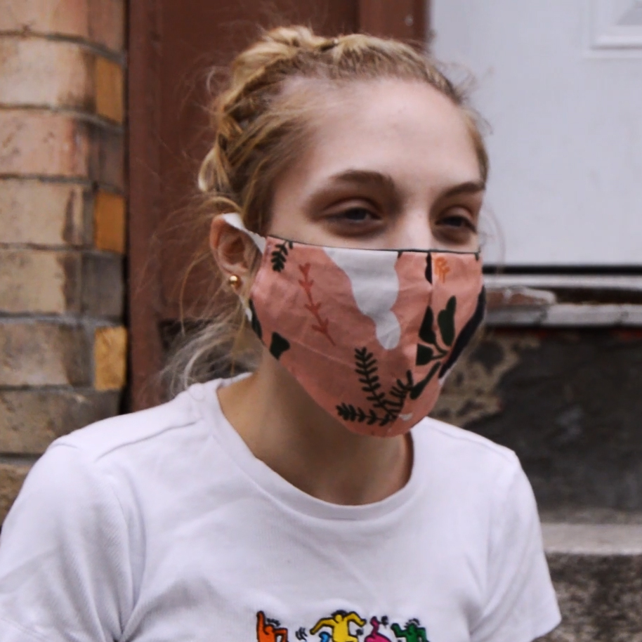 A young white woman wearing a mask